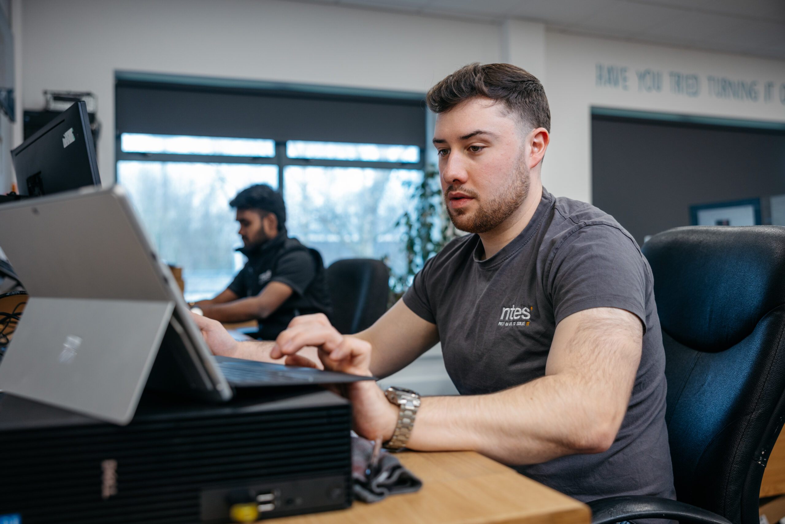 NTES team member working at a desk, reviewing Microsoft 365 data and permissions